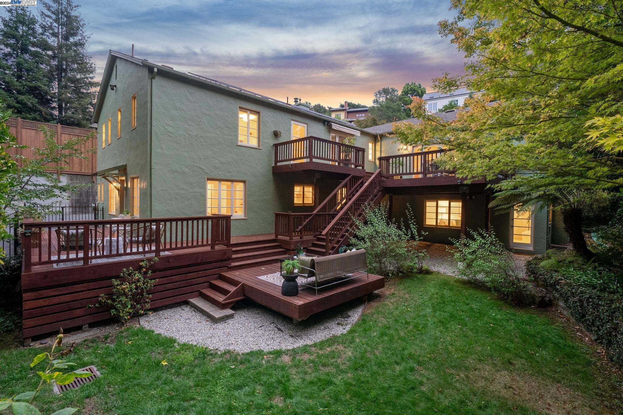 a view of a house with backyard and wooden fence