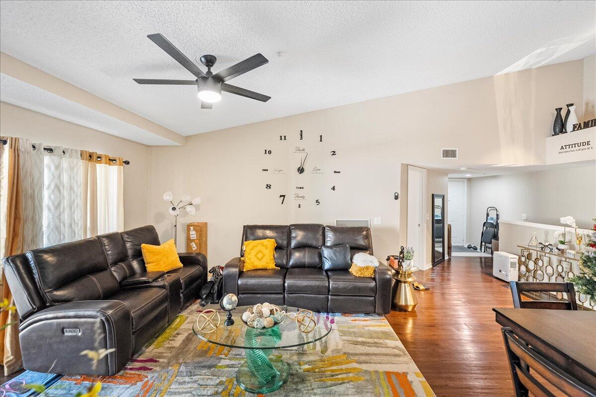 a living room with furniture and wooden floor