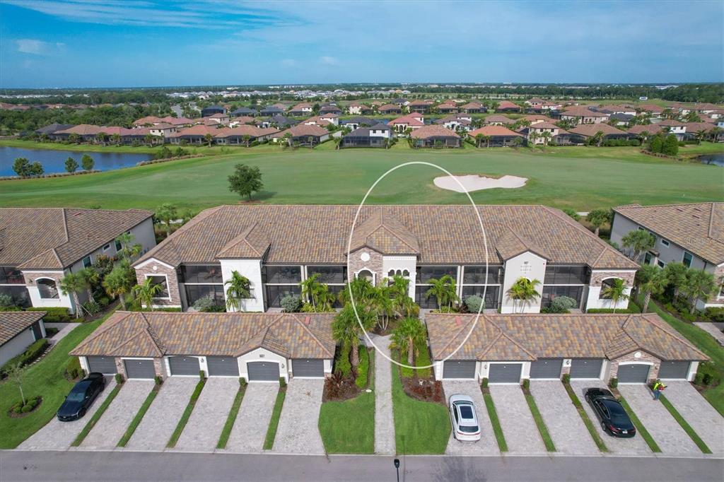 an aerial view of multiple houses with a yard