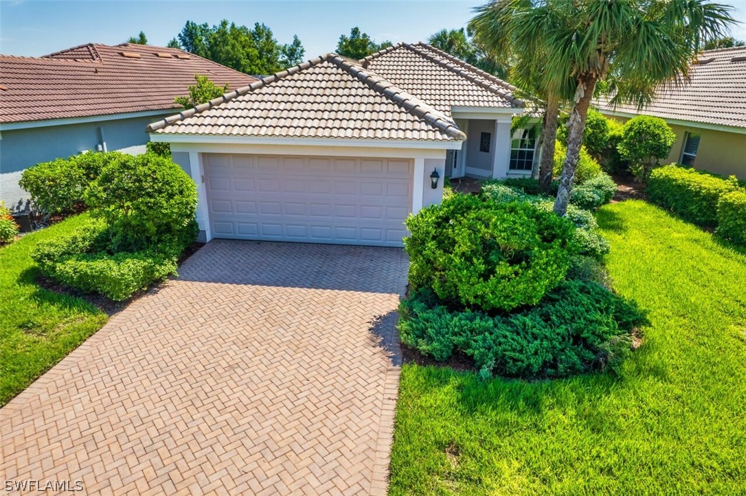 a front view of a house with a yard and garage