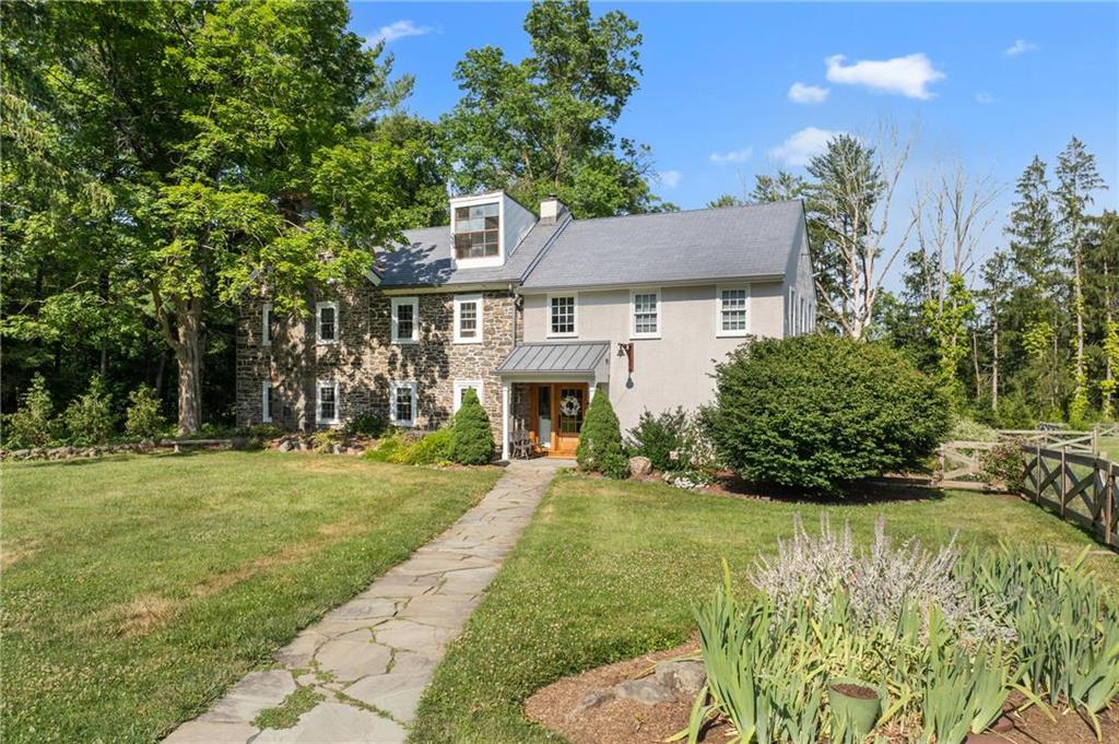 a front view of a house with a garden