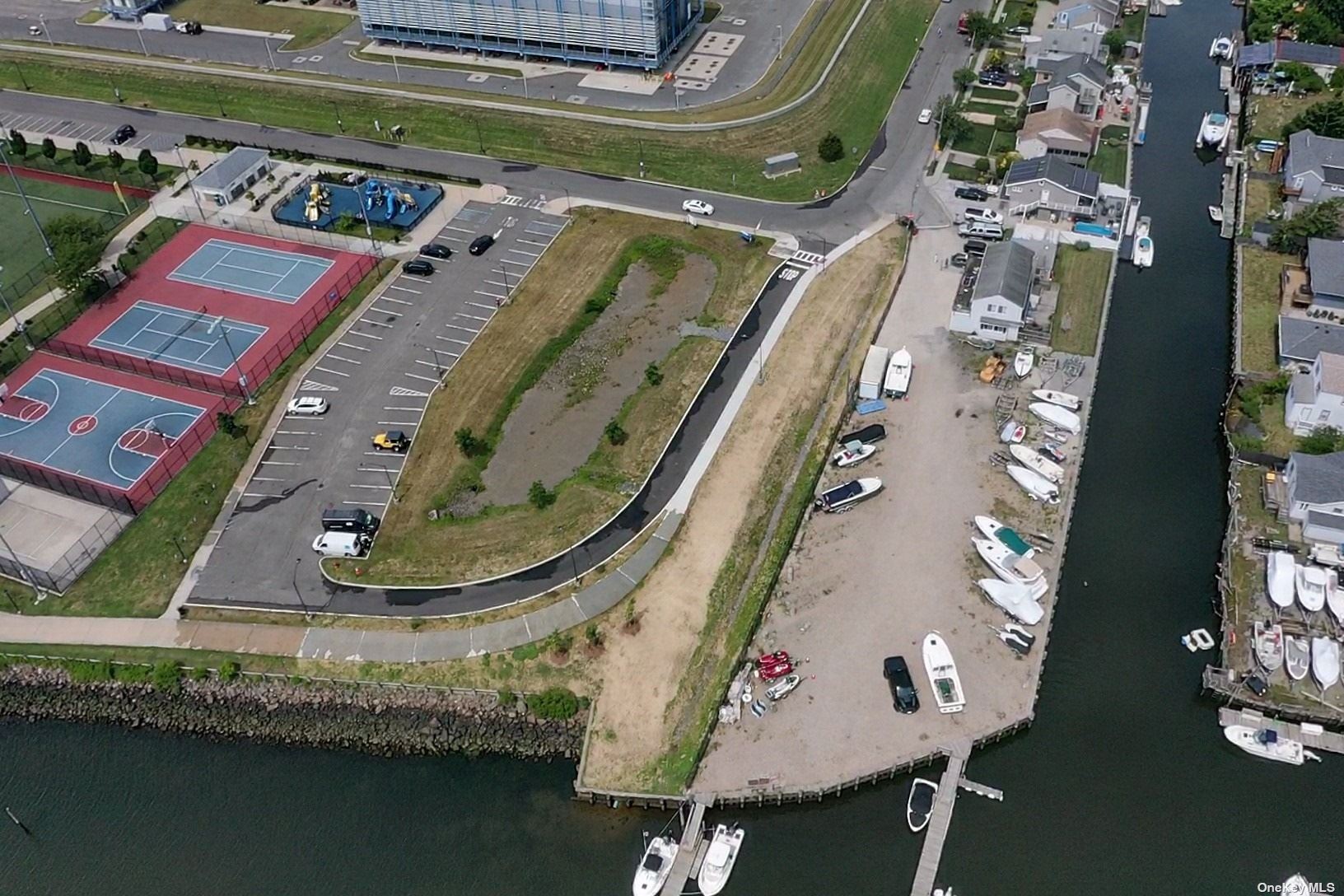 an aerial view of a residential houses with outdoor space and swimming pool