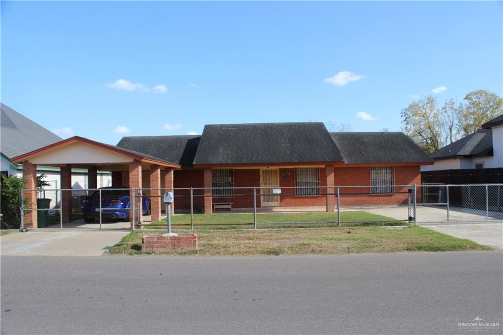 a front view of a building with a garden