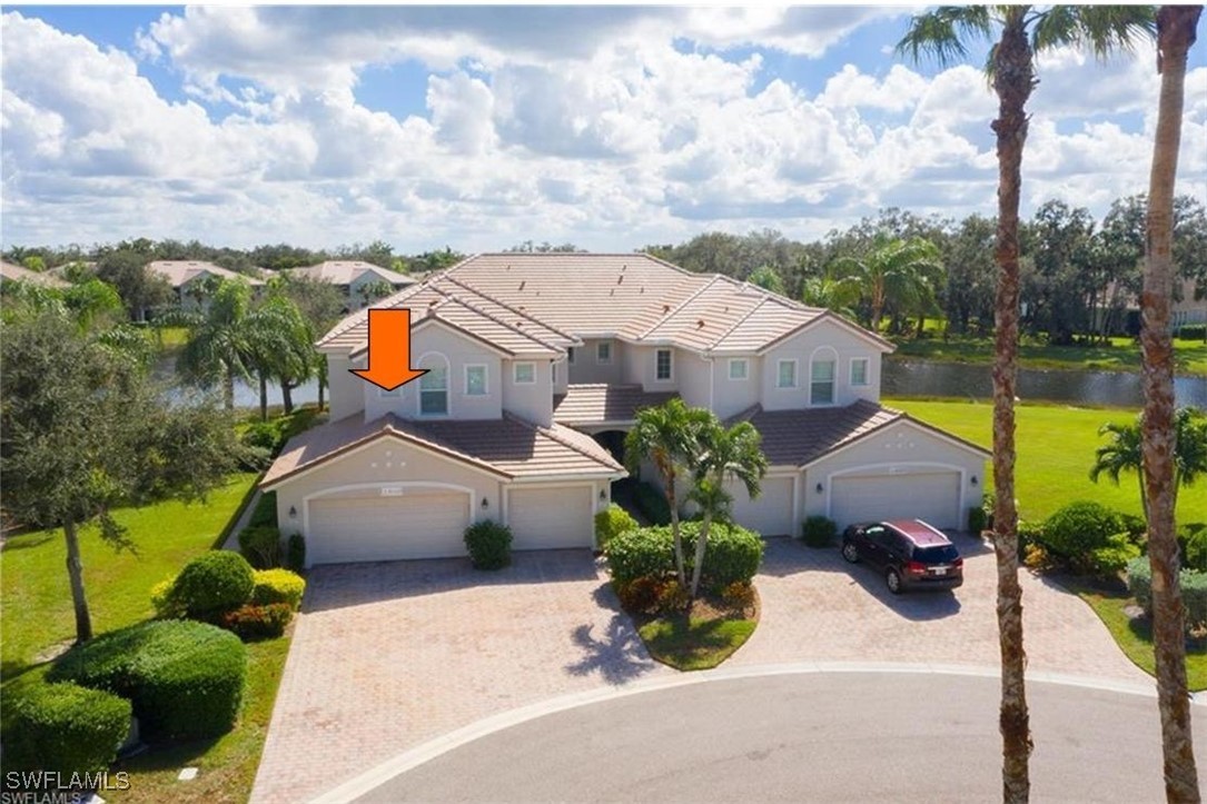 an aerial view of a house with a garden and houses