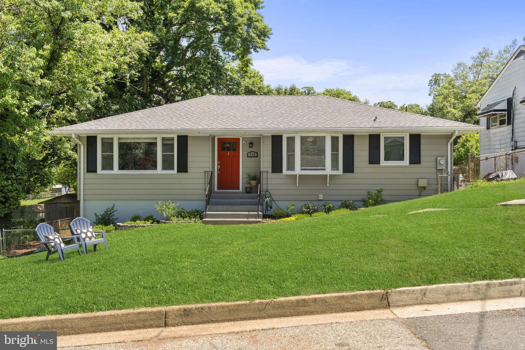 a front view of a house with a garden