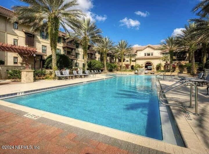 a view of a swimming pool with a lawn chairs