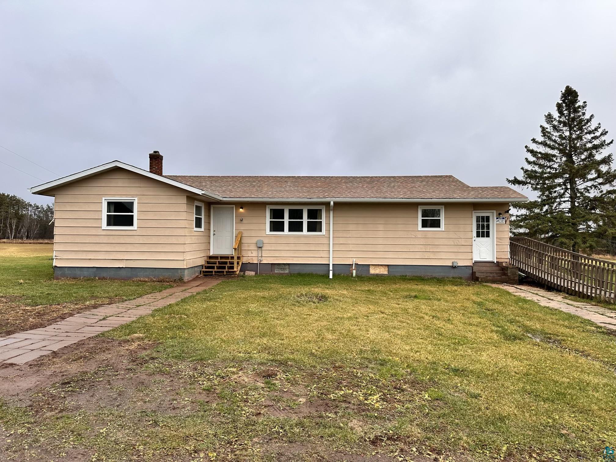 View of front of property featuring a front lawn