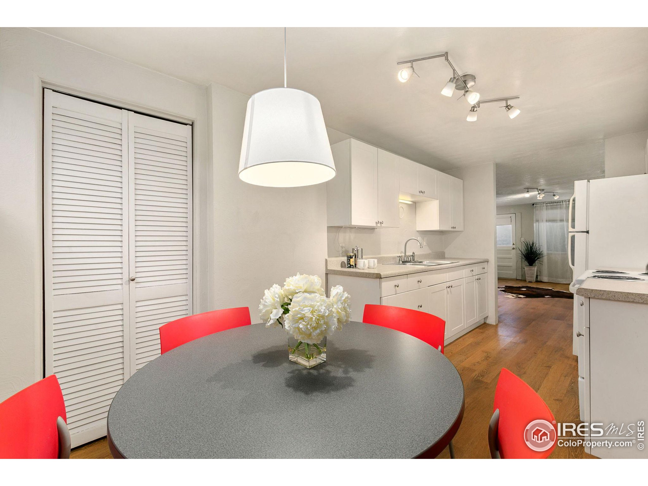 a living room with kitchen island furniture and a chandelier