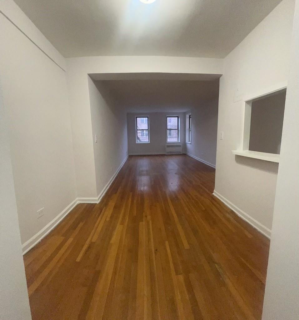 a view of hallway with wooden floor