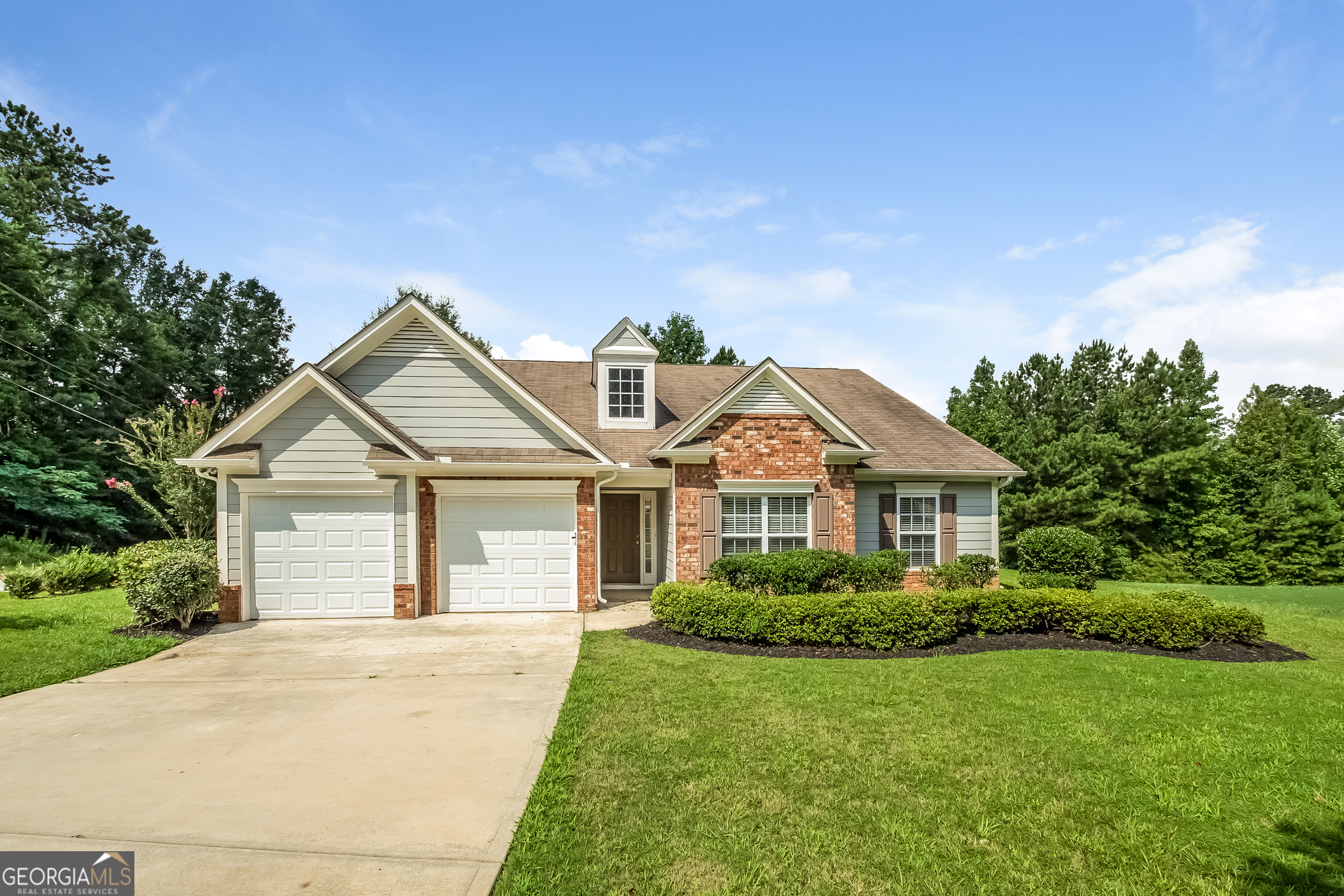 a front view of a house with a garden