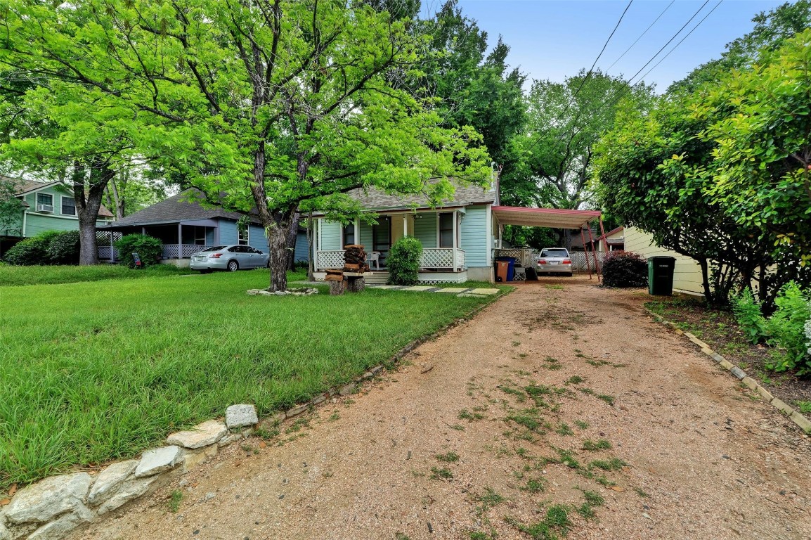 a view of a yard with furniture and a fire pit