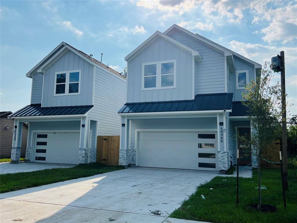 a front view of a house with a yard and a garage