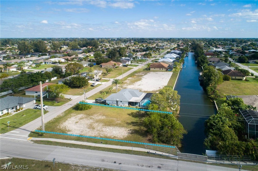 an aerial view of residential houses with outdoor space and swimming pool