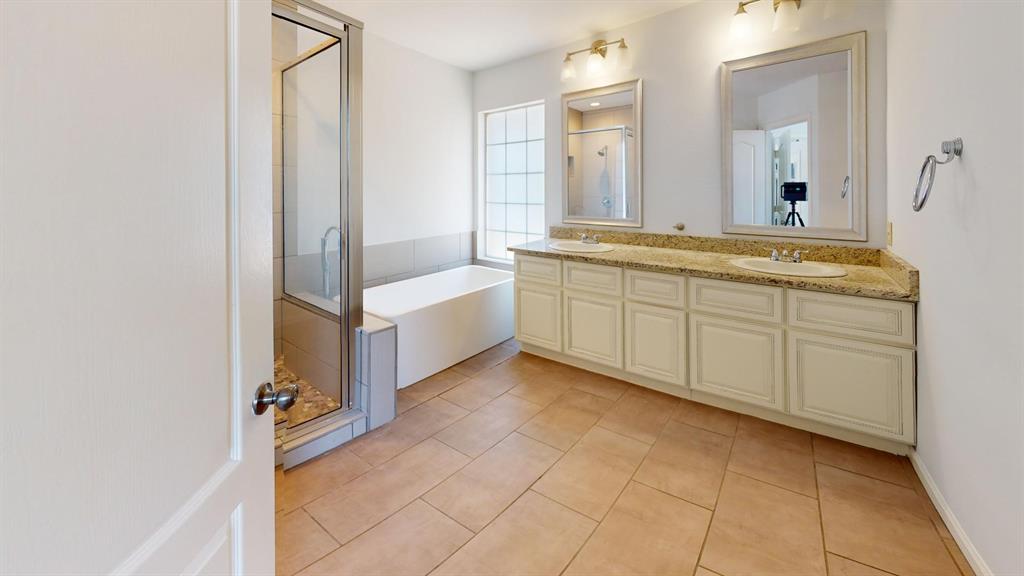 a spacious bathroom with a mirror and a sink