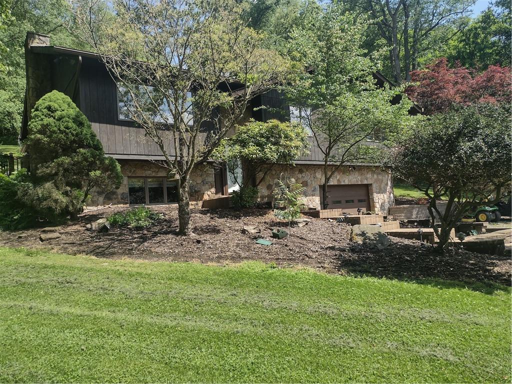 a front view of a house with garden