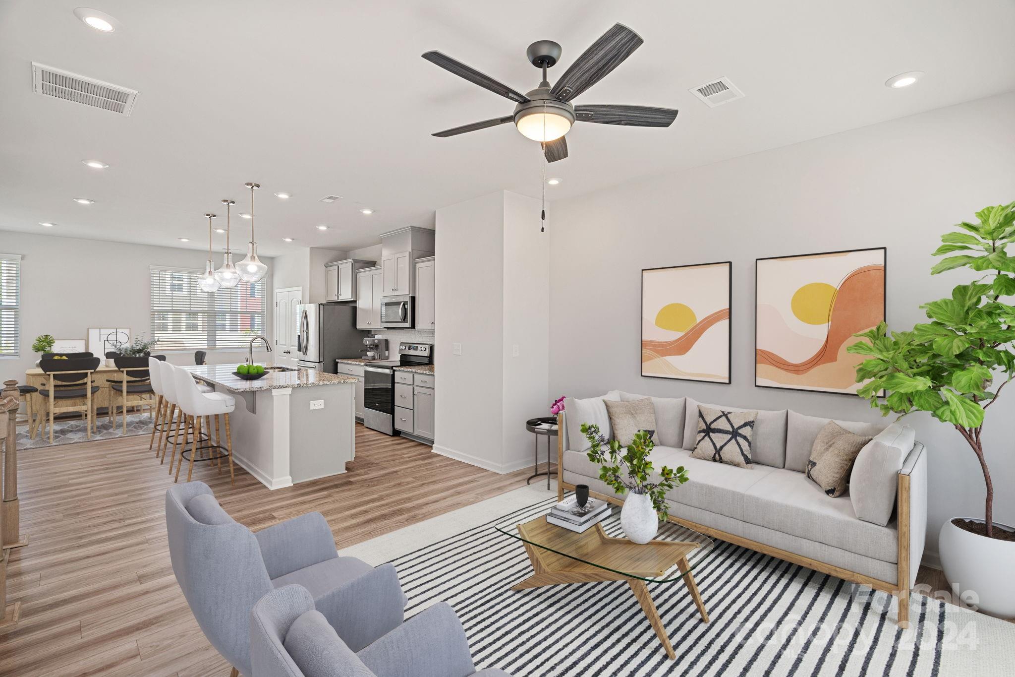 a living room with furniture kitchen view and a table