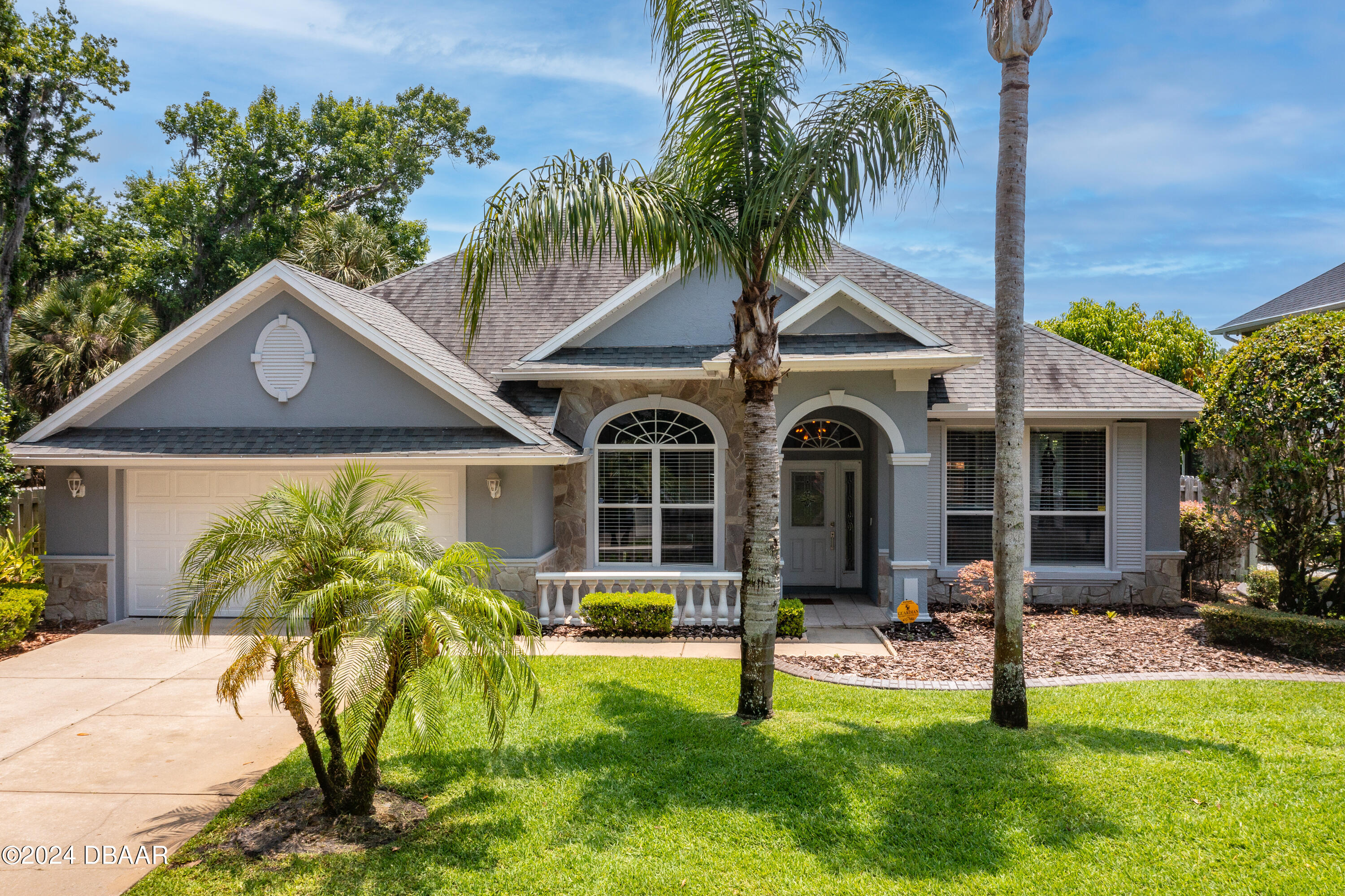 a front view of a house with garden