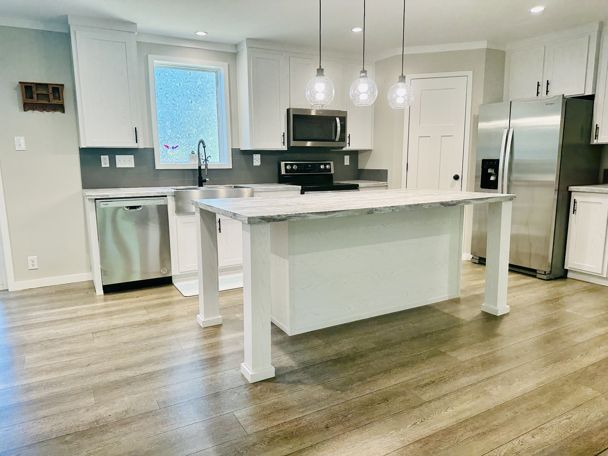 a kitchen with stainless steel appliances a stove a sink and a refrigerator