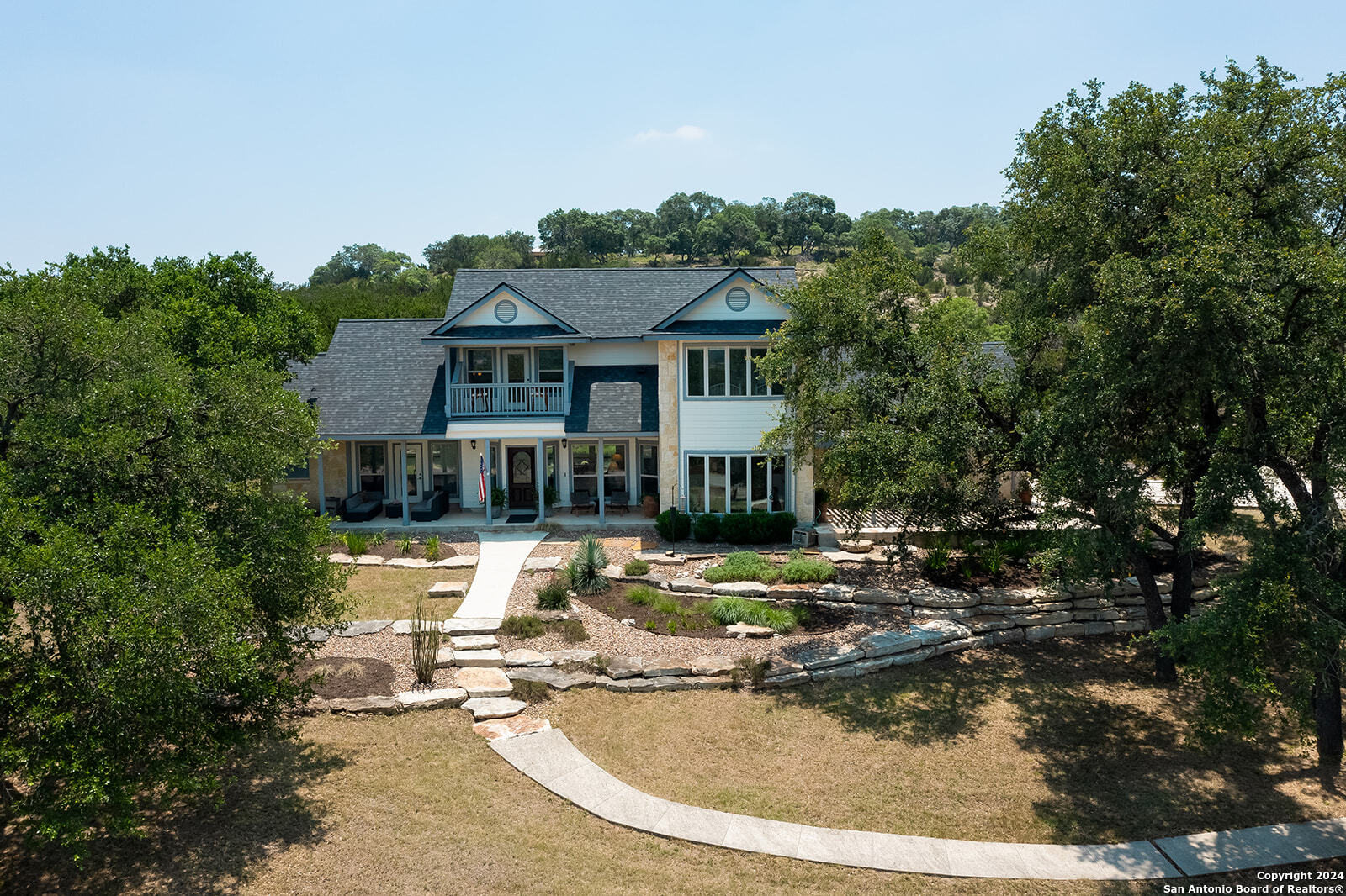 a view of a house with pool and sitting area