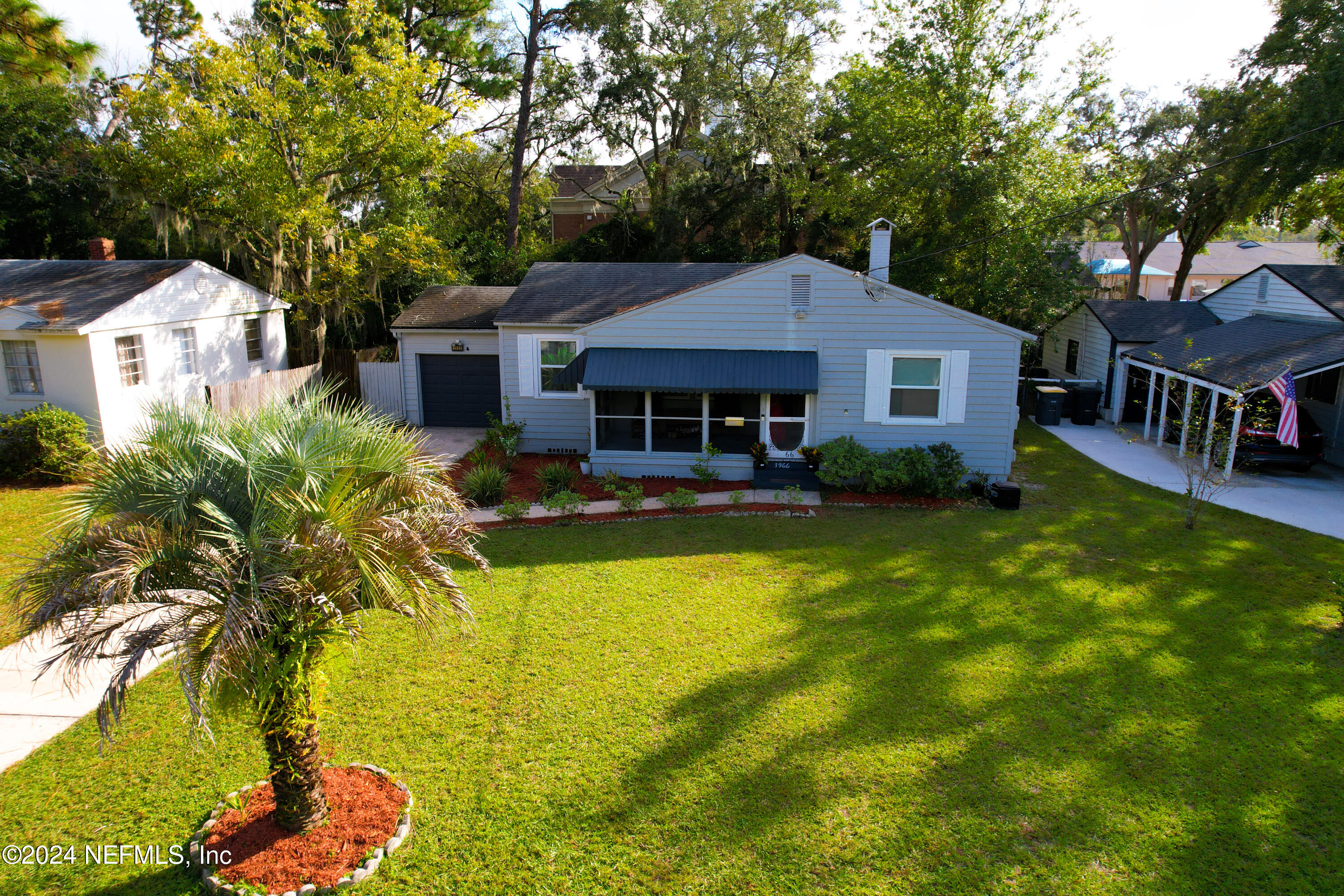 a aerial view of a house with swimming pool yard and outdoor seating