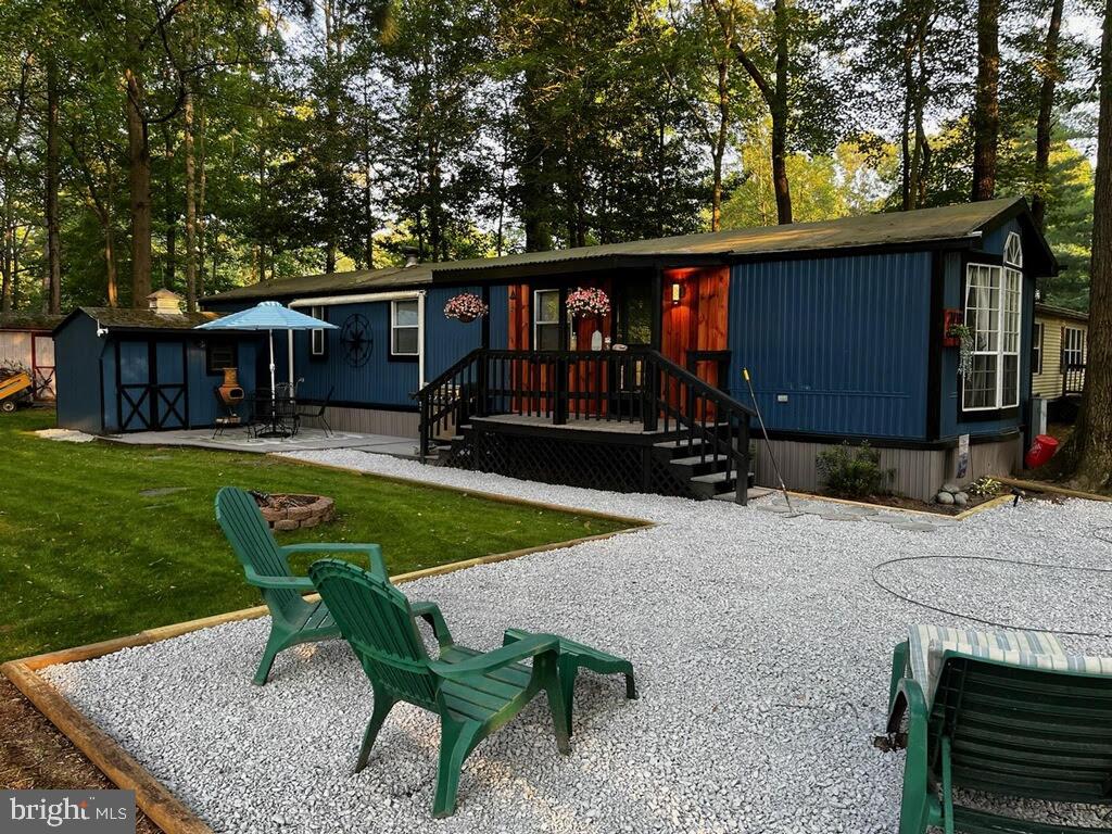 a view of a house with backyard sitting area and furniture