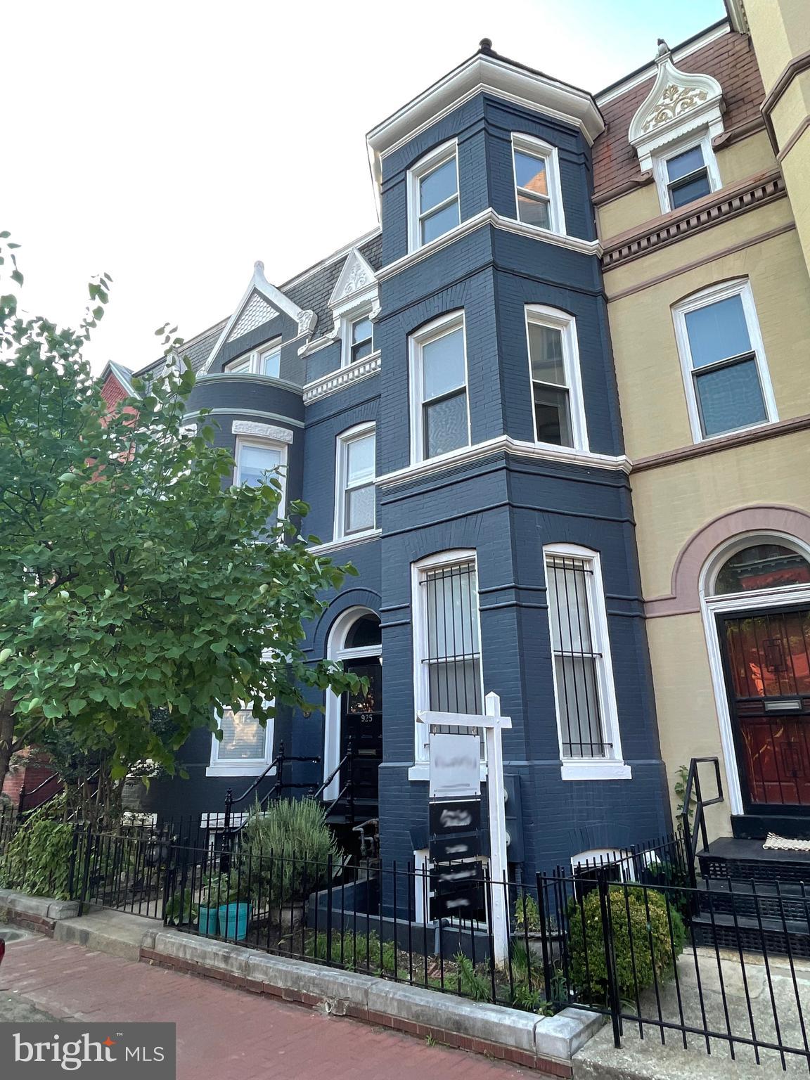 a front view of a residential apartment building with a yard