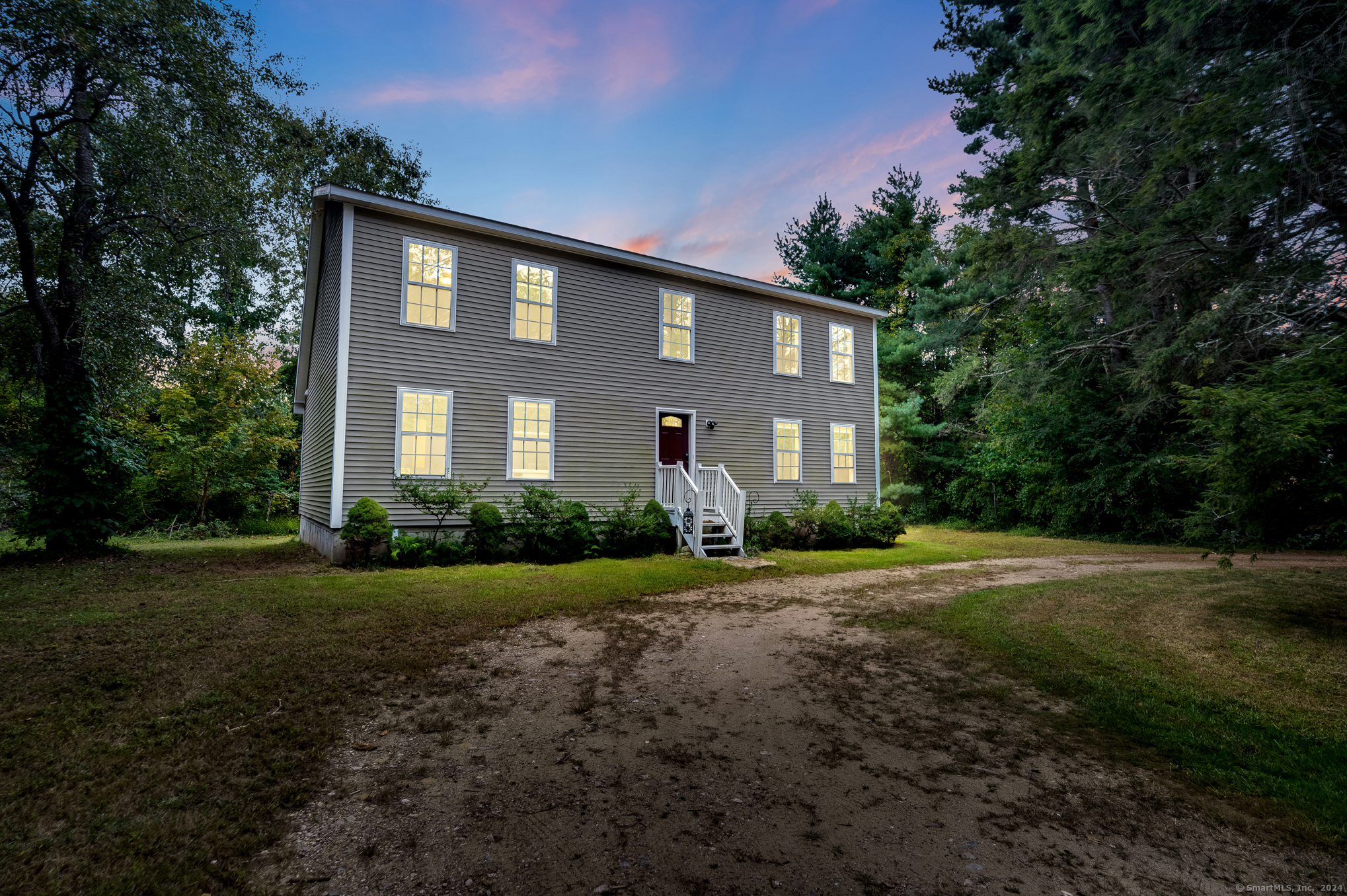 a front view of a house with a yard