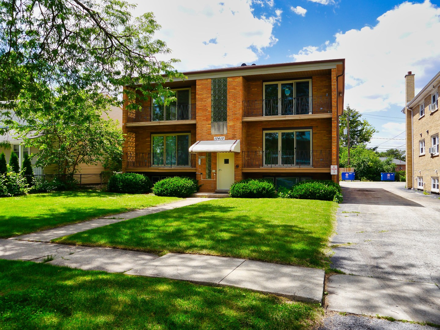 a front view of house with yard and green space