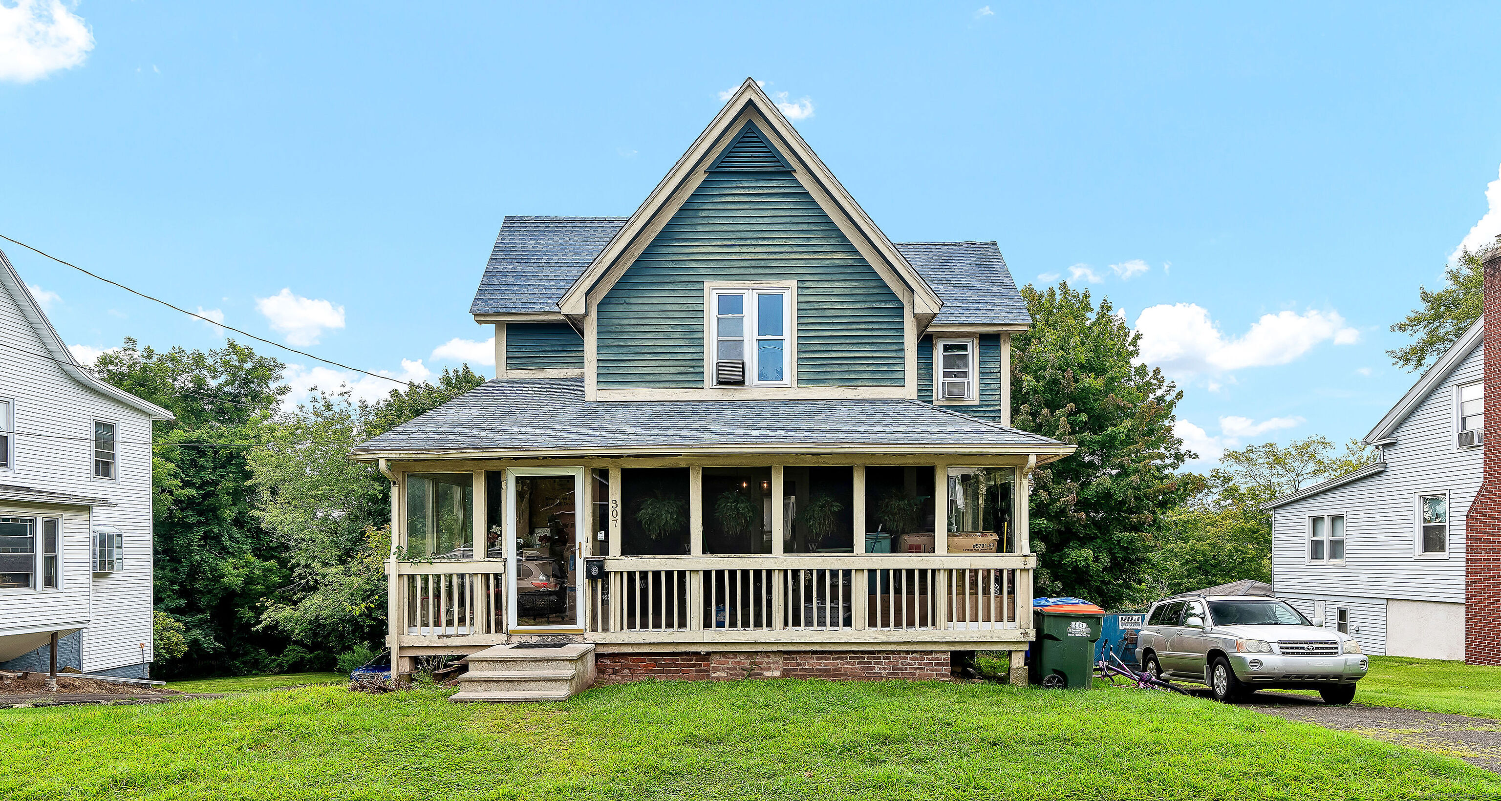 a front view of a house with a garden