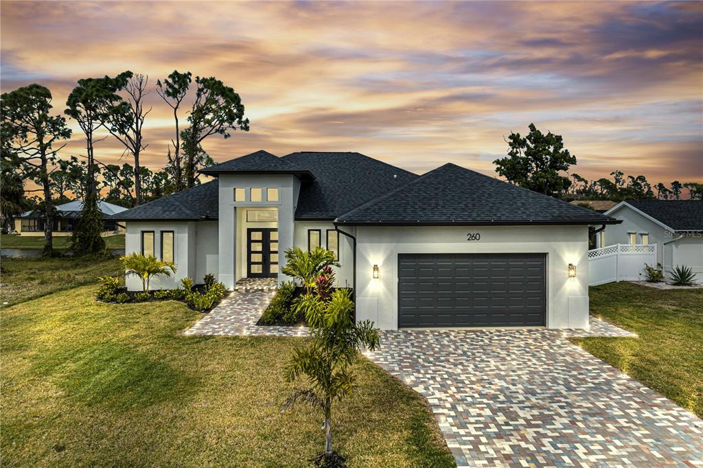 a front view of a house with a garden