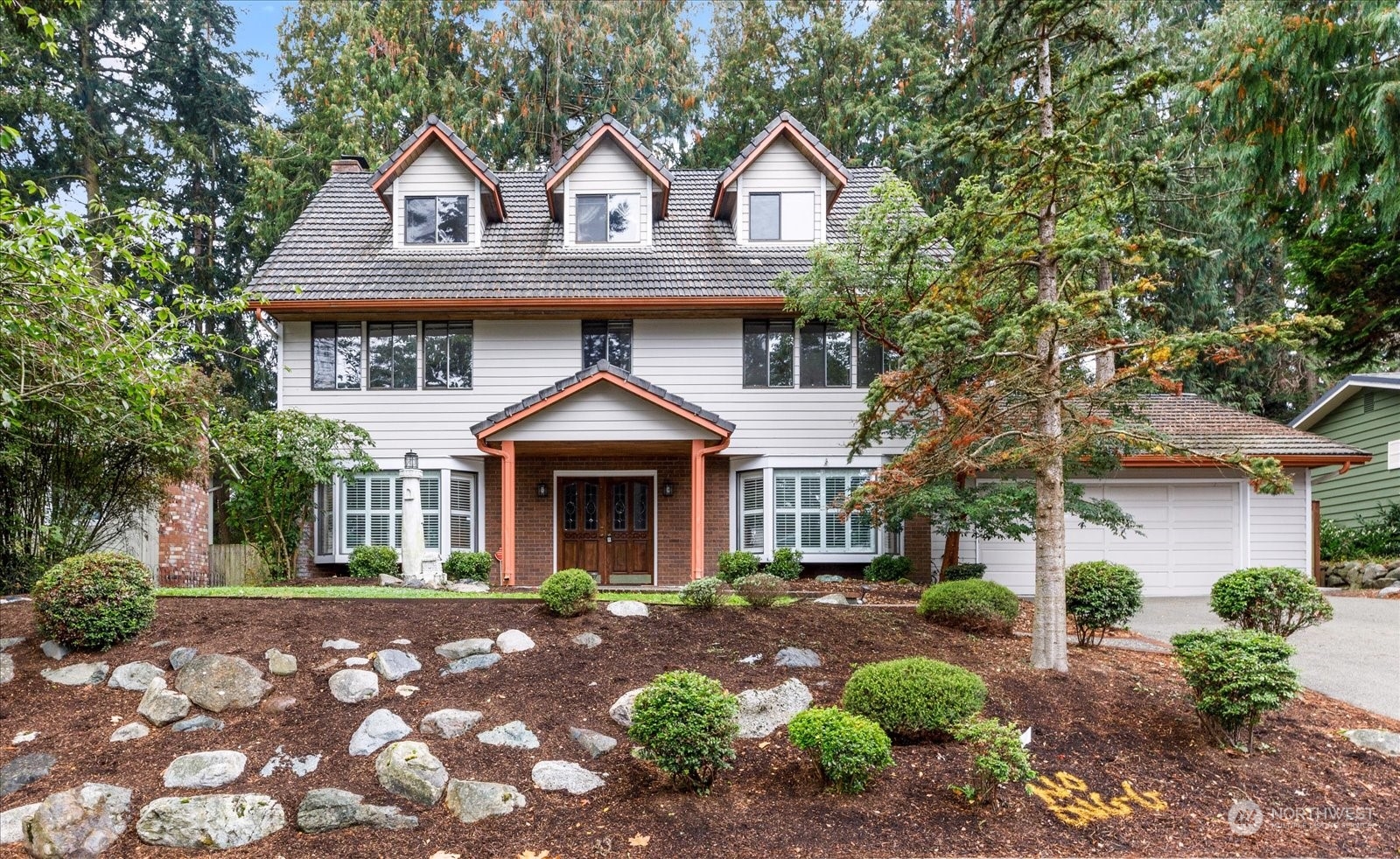 a front view of a house with garden