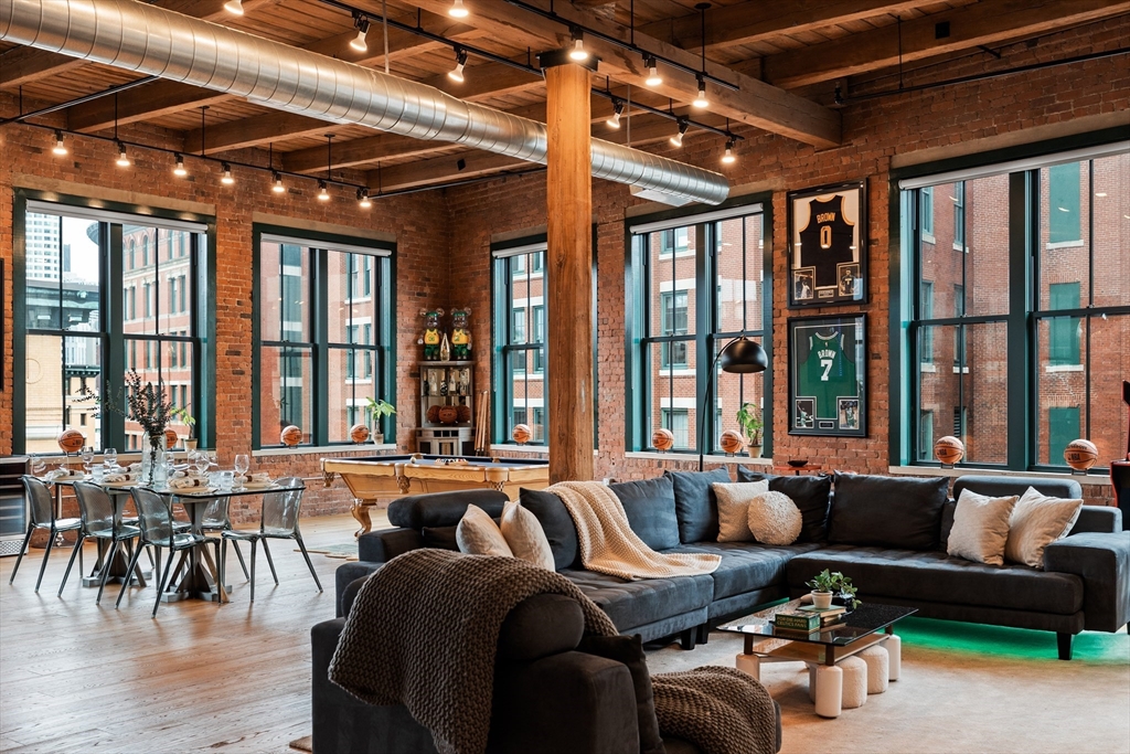 a living room with furniture and large windows