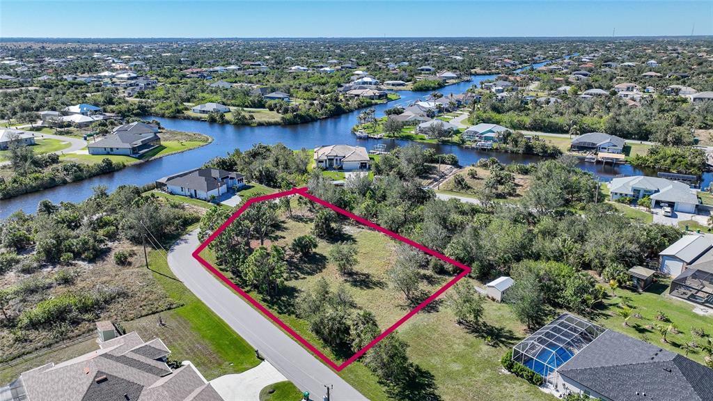 an aerial view of residential houses with outdoor space and lake view