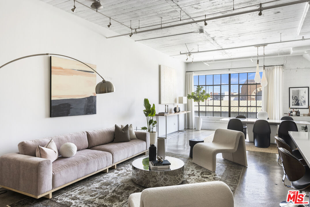 a living room with furniture and a floor to ceiling window