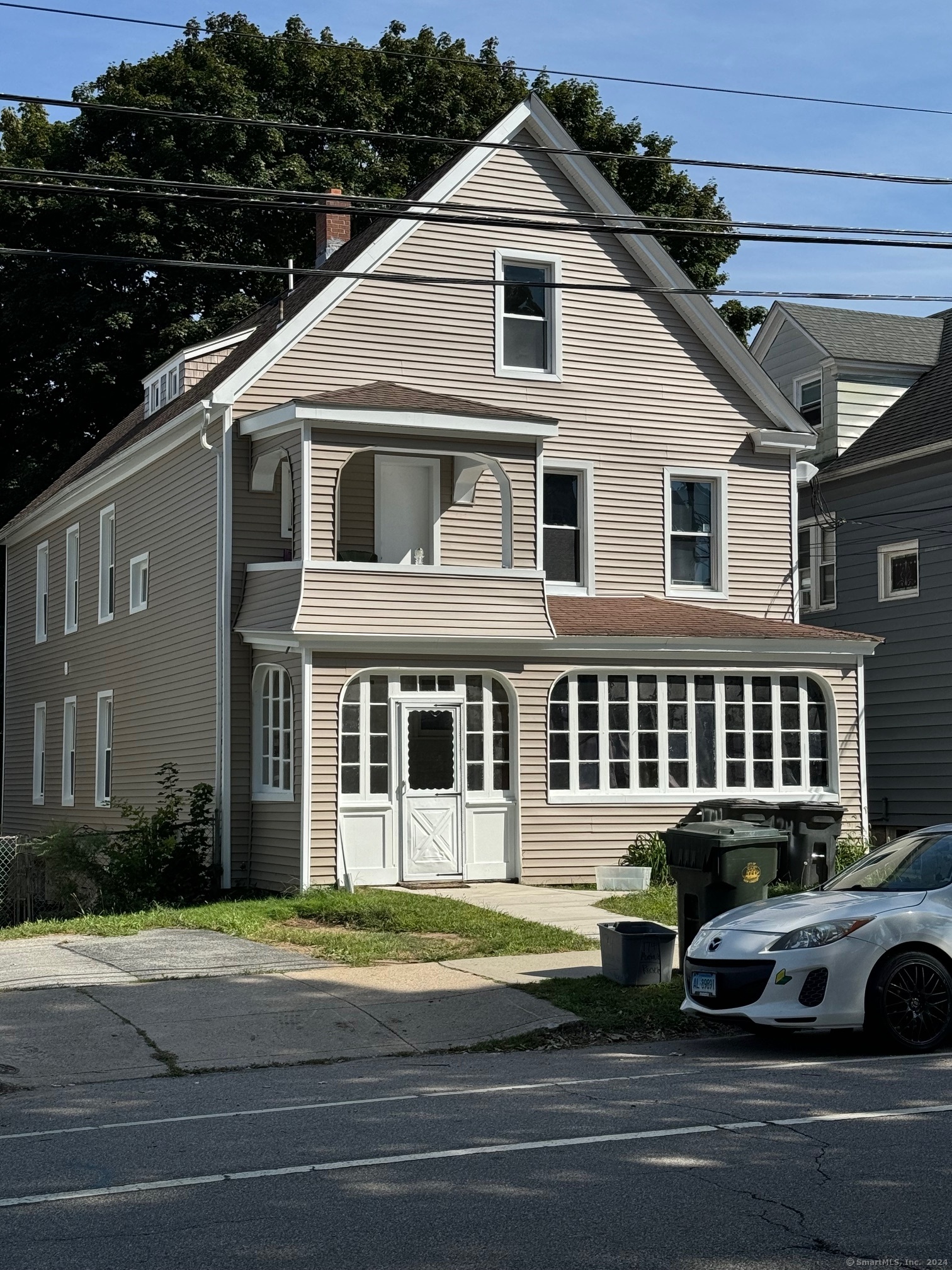 a front view of a house with a garden