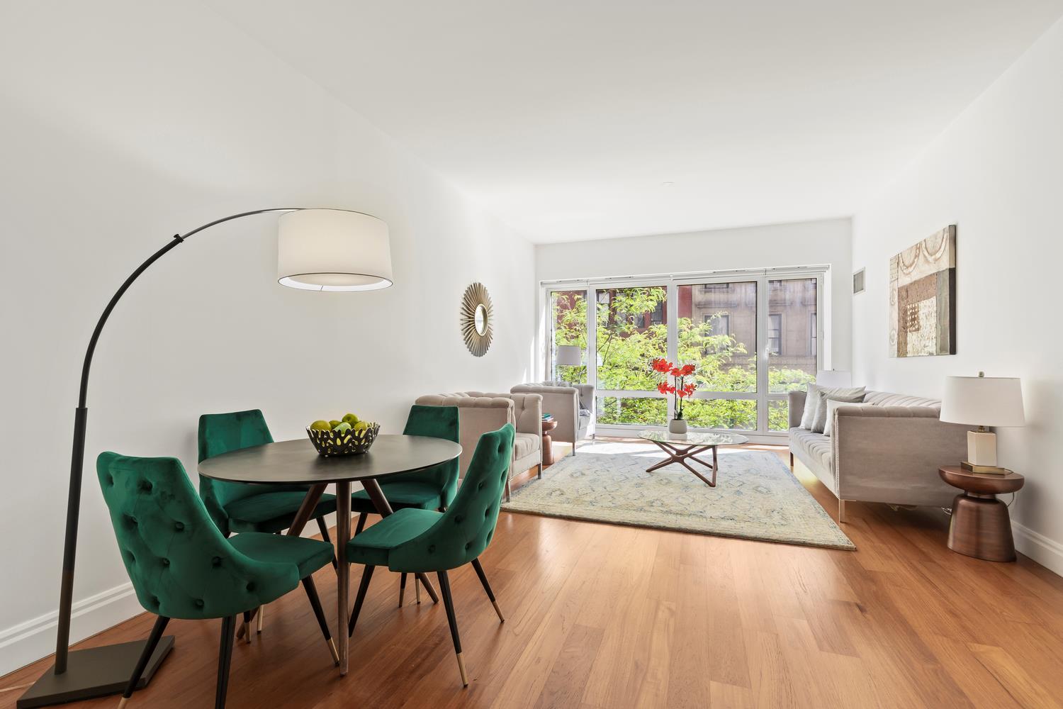 a view of a dining room with furniture window and wooden floor