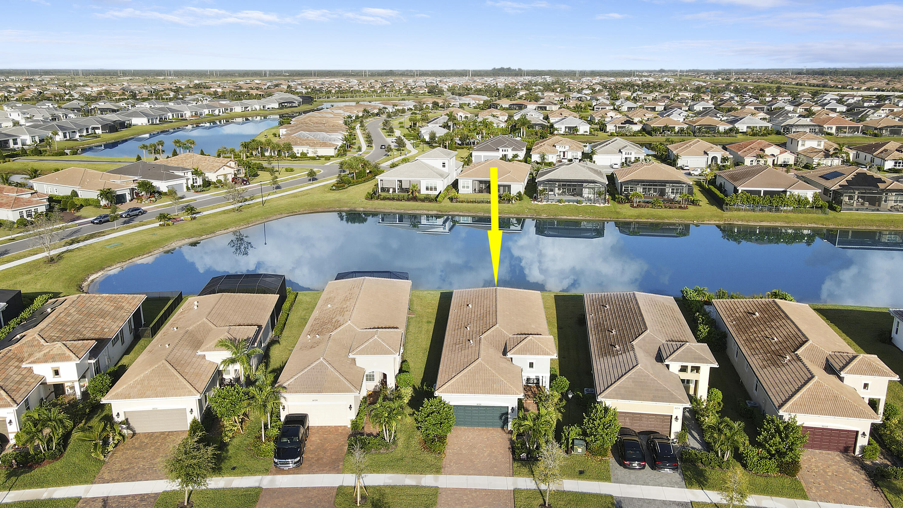 an aerial view of residential houses with outdoor space and swimming pool