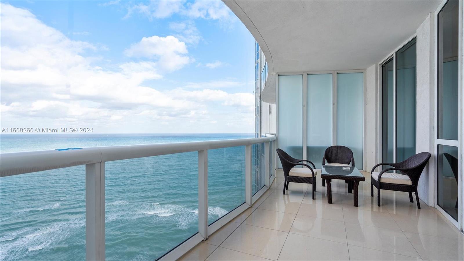 a balcony with chairs and a table