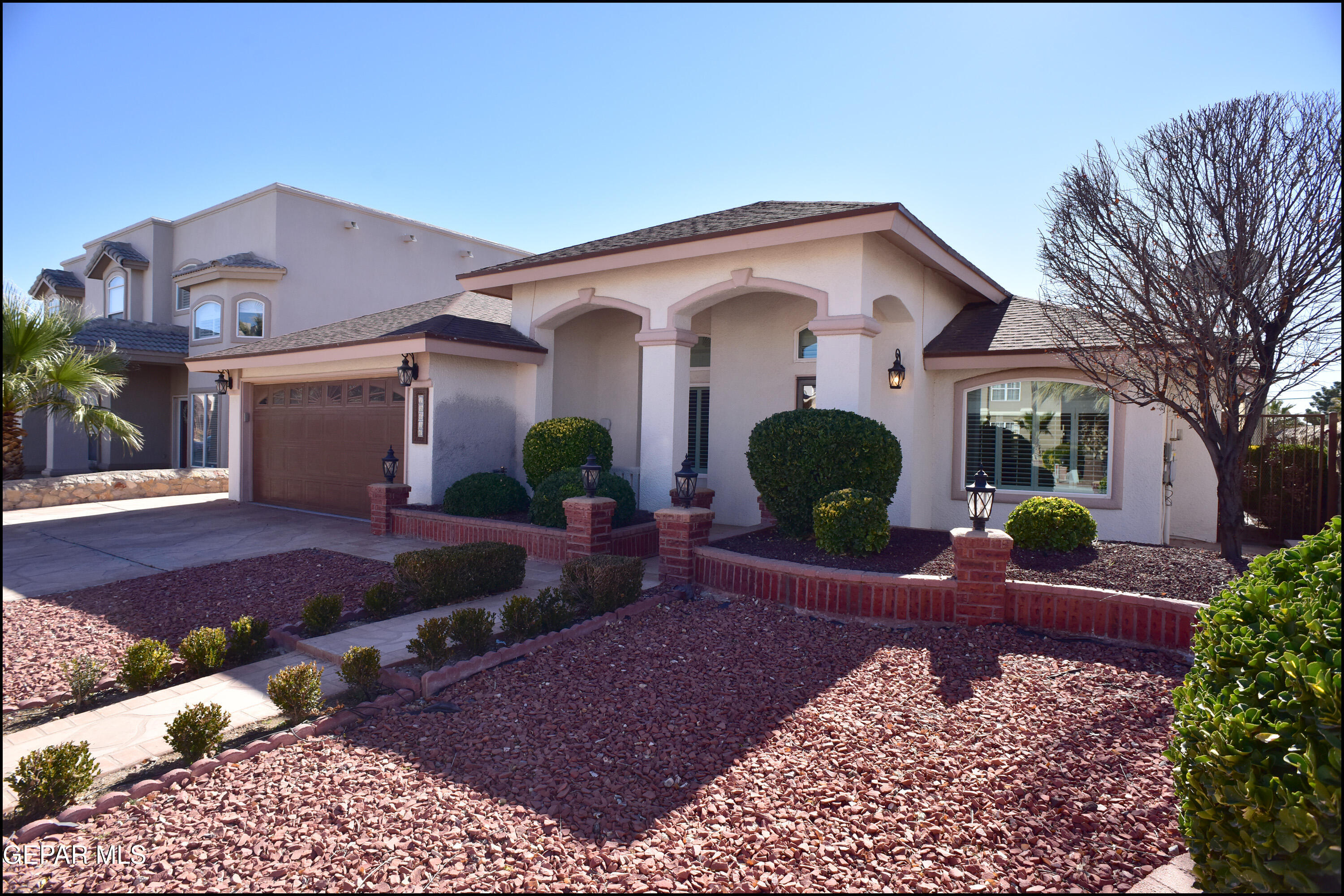 a front view of a house with garden