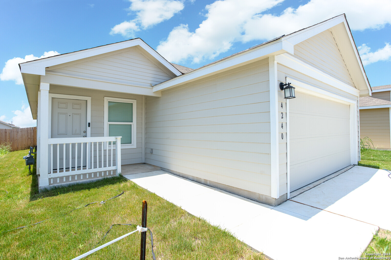 a view of a house with wooden deck and furniture