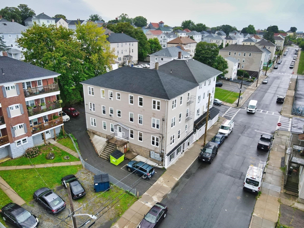 an aerial view of multiple houses with yard