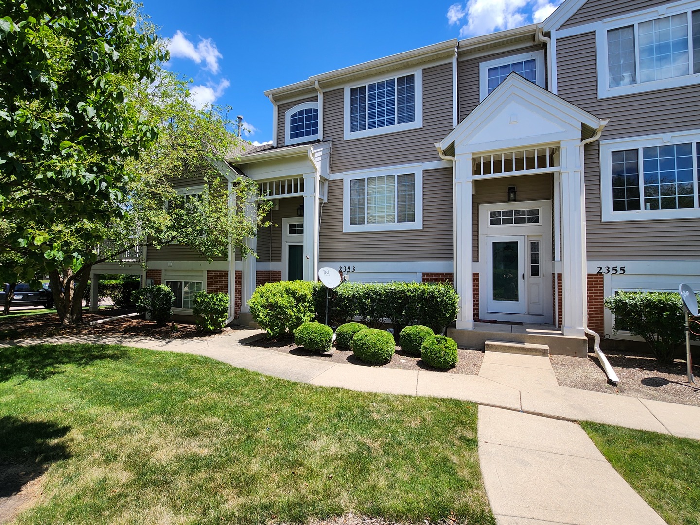 a front view of a house with a yard