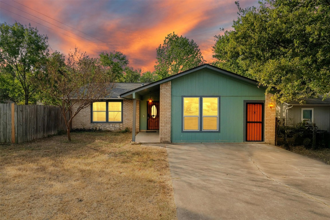 a view of a house with a backyard and a garage