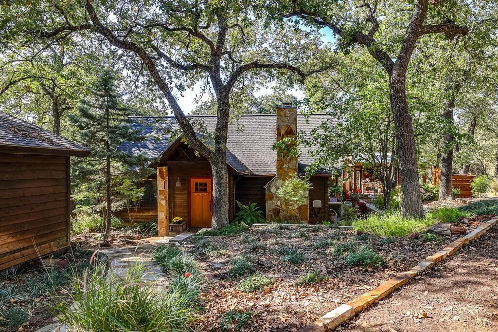 a view of a house with a tree and a yard