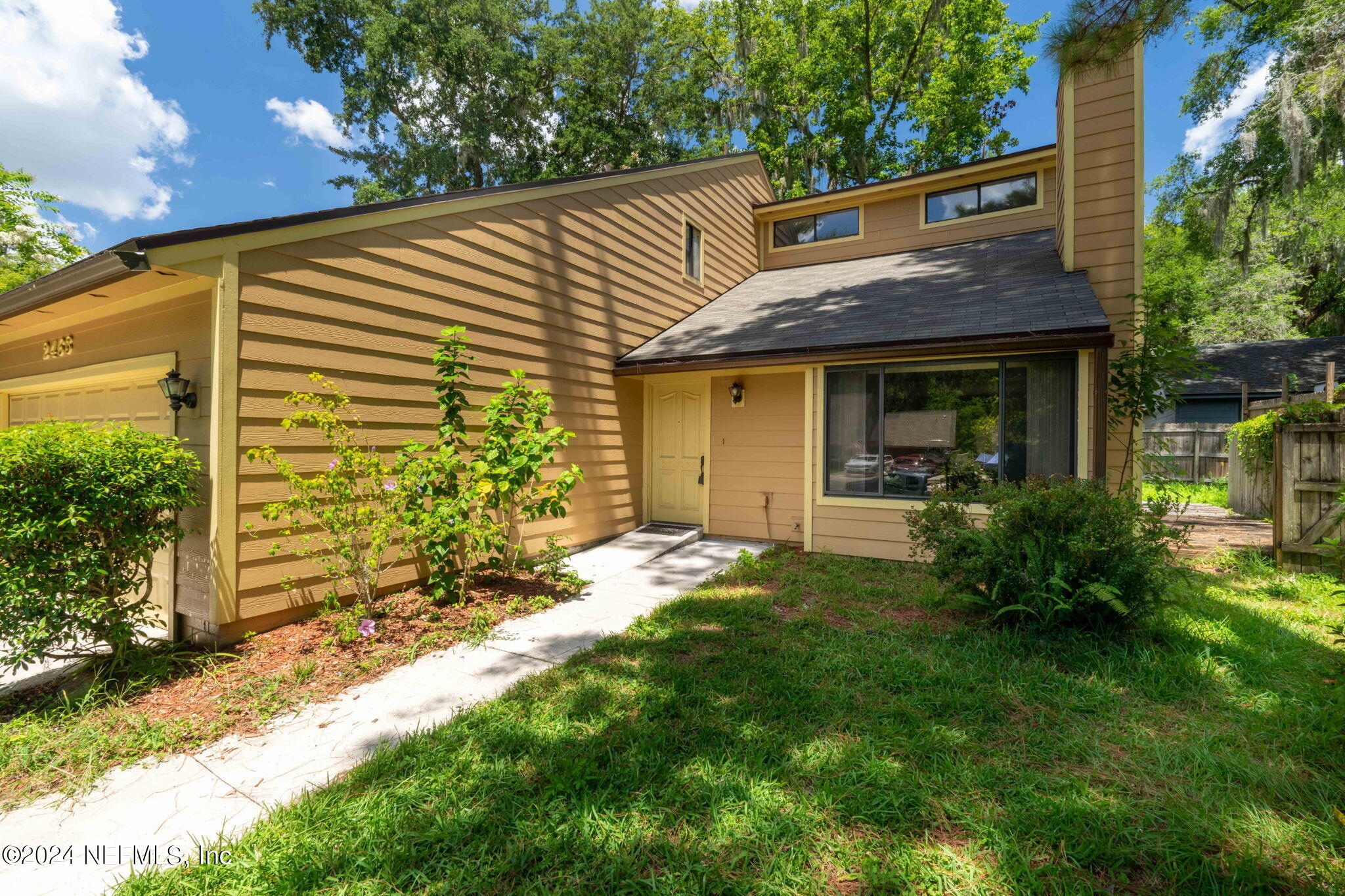 a view of a house with a yard and plants