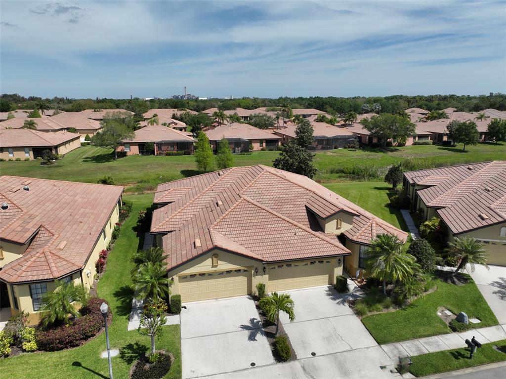 an aerial view of a house with a garden and lake view