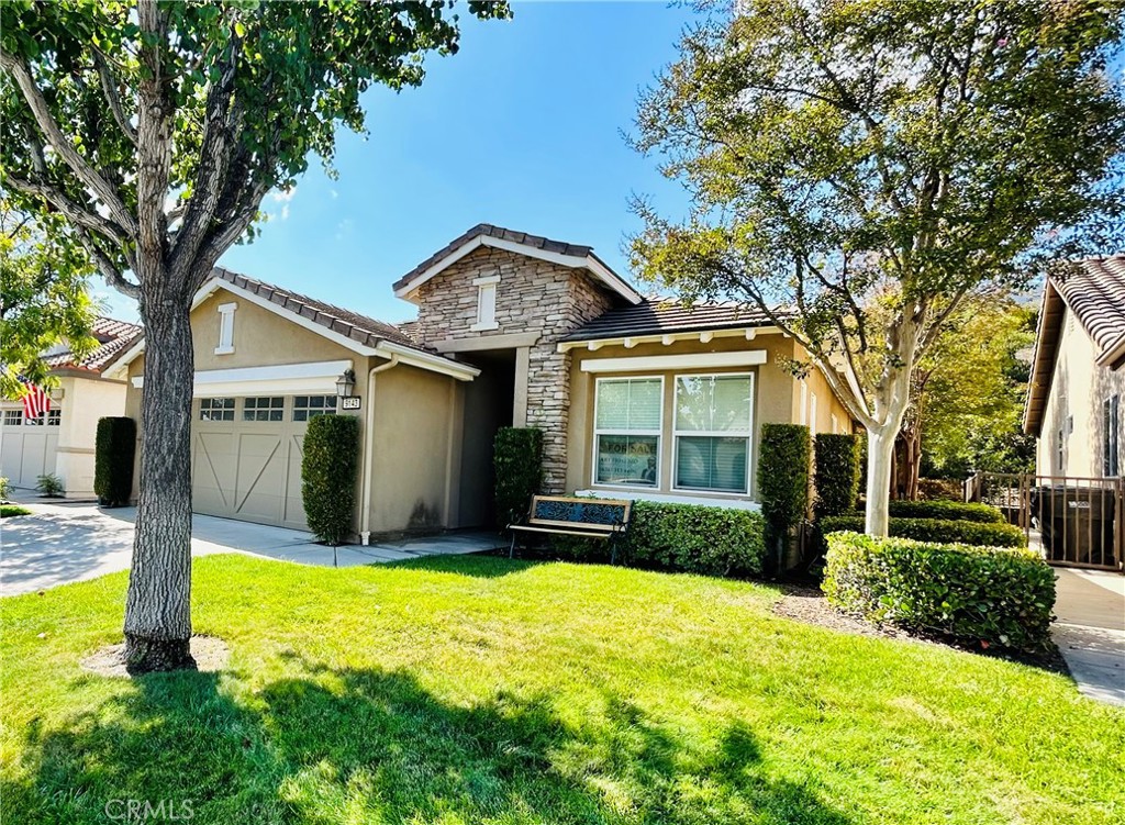 a view of a house with swimming pool next to a yard