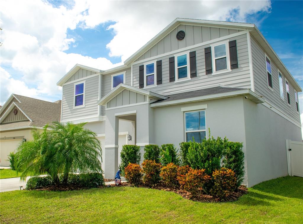 a front view of house with yard and green space