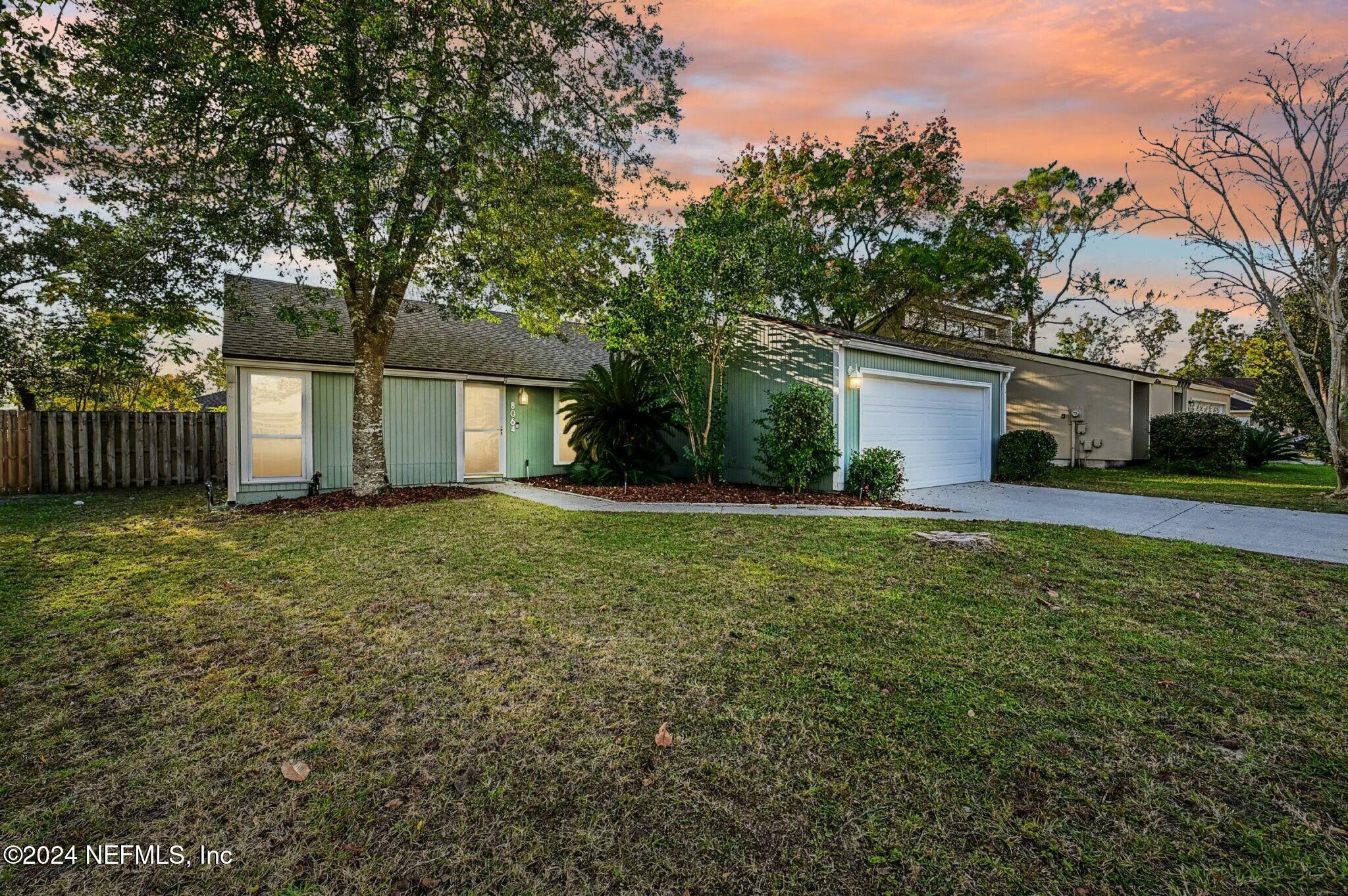 a front view of house with yard and green space