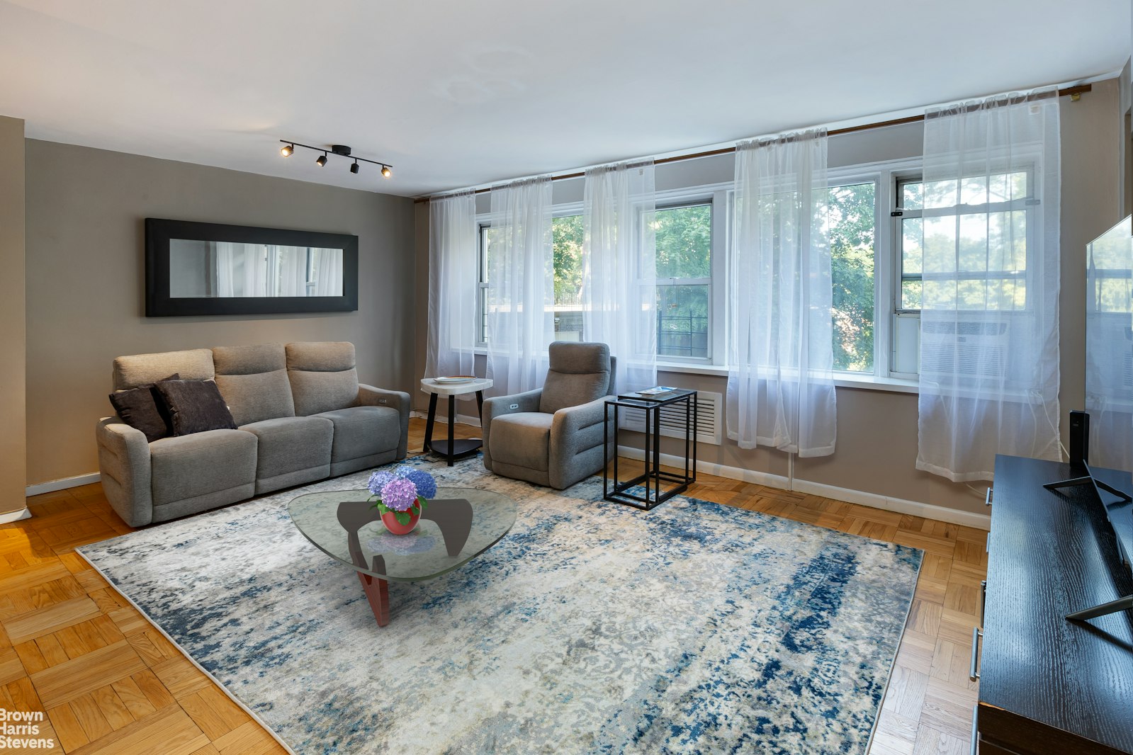 a living room with furniture and a large window